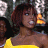 A 48x48 pixel buddy icon featuring a woman in a yellow dress on the left and green text reading "Original Icons .com" on the right, with visible pixelation and dithering effects.