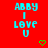 Red background with cyan text reading 'ABBY I LOVE U' and two green pixelated hearts below the text.