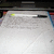 A static image shows a piece of paper with a pen on it, overlaid with pixelated text reading 'writing is an ART!! vickedly secret' on a black background.