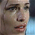 Pixelated close-up of a person's face with visible eyes, nose, mouth, and partial hair against a gradient background.
