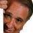 Pixelated close-up of a person's face showing forehead, eyes, nose, and mouth with brown hair visible on the right side.