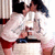 Two figures in white and red clothing embrace closely, one figure's head moves slightly forward and back across frames.
