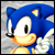 Pixelated blue hedgehog with white muzzle and orange nose, smiling with closed eyes, static image with gray background.