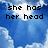 Pixelated blue sky background with white clouds and black pixelated text reading "she has her head up in the clouds!".