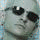 A pixelated animated icon shows a figure with dark hair and light clothing against a muted background, transitioning from a side profile to a front-facing pose.