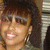 A static pixelated image shows a person with short brown hair, light skin tone, and visible teeth in a slight smile.