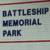 Static pixelated image with three lines of dark blue text on light gray background, bordered by thin red horizontal lines at top and bottom.