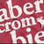 Pixelated white text on a red background with overlapping letters forming a dense wordwall of partially readable words.