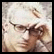 Two side-by-side frames from an animated AIM buddy icon showing a person with light hair and glasses on the left, and stylized text/graphics on the right.