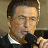 A 48x48 pixel buddy icon featuring a split composition with a person holding a microphone on the left and red text reading "Along Came Polly" on the right, displayed as part of an animated contact sheet.