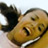 Pixelated close-up of a cartoon character's face with yellow skin, dark hair, and visible facial features including eyes, nose, mouth, and chin.