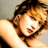 Static pixelated image of a person with light brown hair and fair skin, cropped to show upper face and shoulder against neutral background.