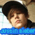 Pixelated image of a person with dark hair and light skin, wearing a black top against a beige background with blue text reading 'justin bieber' at the bottom.