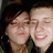 Two people in close proximity with one person's head resting on the other's shoulder, both smiling broadly.