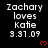 Pixelated text reads "Zachary loves Katie 3.31.09" with red heart symbols on black background, repeated in with gray area at bottom-right