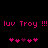 Pixelated pink text and heart symbols on a black background, with repeated 'luv Troy !!!' phrases and alternating heart patterns.
