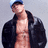 A pixelated image of a person wearing a dark jacket and blue cap, with a red text logo on a black background.