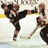 Pixelated hockey player in dark uniform skating on ice with stick, surrounded by red text on black background.