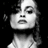 A static image with a split composition: a grayscale portrait of a person on the left, and green pixelated text on dark blue and gray backgrounds on the right.