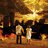 Two pixelated figures stand side-by-side against a fiery orange and brown background with a bright yellow sunburst at the top.