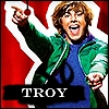 Pixelated image of a person in a green jacket and blue shirt pointing upward with a red background and white outline.