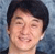 Pixelated close-up of a person with short dark hair against a blue-gray gradient background, showing a smiling expression with closed eyes.