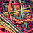 A static pixelated image with a dense, multicolored composition of overlapping geometric shapes and lines in hues of red, orange, yellow, green, blue, purple, and black.
