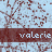 A static image with a light blue background patterned by dark red branching lines, overlaid with repeating text 'valerie' in white on brown horizontal bars.