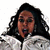A person with long dark curly hair wears a white jacket, mouth open in an expressive pose against a plain background.