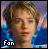 Pixelated static image of a person with light brown hair wearing blue clothing, featuring the text "Fan" in white pixel art at bottom left against a multicolored background.