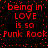 Red pixelated text on black background repeats 'being in LOVE is so Punk Rock' with scattered red dots, animated to shift horizontally.
