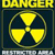 Yellow radiation symbol on dark background with 'DANGER' text above and partial text below, all in pixelated style.