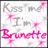 Pixelated static icon with pink and gray text reading "Kiss Me I'm Brunette" surrounded by pink starbursts on a white background.