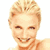 Pixelated static image of a smiling person with short blonde hair and visible facial features against a white background.