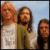 Three pixelated figures stand side-by-side against a light blue background, each with distinct clothing and hair colors.