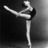 Black-and-white photo of a dancer in a high kick pose on a dark background, with pink text reading "Dance..." and "Like No Ones Watchin'" on adjacent pink