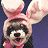 Pixelated static icon of a ferret wearing pink bunny ears with red accents, dark eyes, and an open mouth showing teeth against a solid blue background.