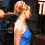 A four- shows a person in blue and white clothing with blonde hair styled up, transitioning between side profile and front-facing poses against dark background