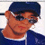 A pixelated contact sheet showing two frames of an animated buddy icon with a person wearing sunglasses and a cap on the left, and green text reading "Original Icons .com" on a dark background on the right.