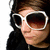 A person with long dark hair wearing white-framed sunglasses and a black top, shown in a of four with one blank