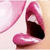 Pixelated close-up of a mouth with pink lips, dark interior, and visible teeth against light background.