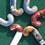 Pixelated image with green background and colorful curved shapes on left, pink background with black text on right.