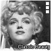 Black-and-white image of a woman with curly blonde hair, wearing a white collared shirt, displayed in a