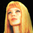 Static pixelated image of a person with long blonde hair against black background, rendered in warm yellow-orange tones.