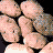Pixelated image of multiple potatoes with text reading 'potato=' and 'the best stuff ever!!' on a gray background.