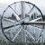 Circular icon with a grayscale cityscape view through a transparent dome, featuring buildings and a bridge under a light sky.