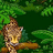 A pixelated cheetah on a branch in a green forest background, with visible animation frames showing partial cropping.