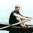 Animated sequence of a person rowing in a boat, showing four distinct phases of the rowing stroke from forward to backward position.