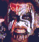 Two vertical show a pixelated face with white and red paint, mouth open in a grimace, eyes closed or squinted, dark background