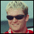 Pixelated of four showing a person, text, and race car with patriotic flag elements